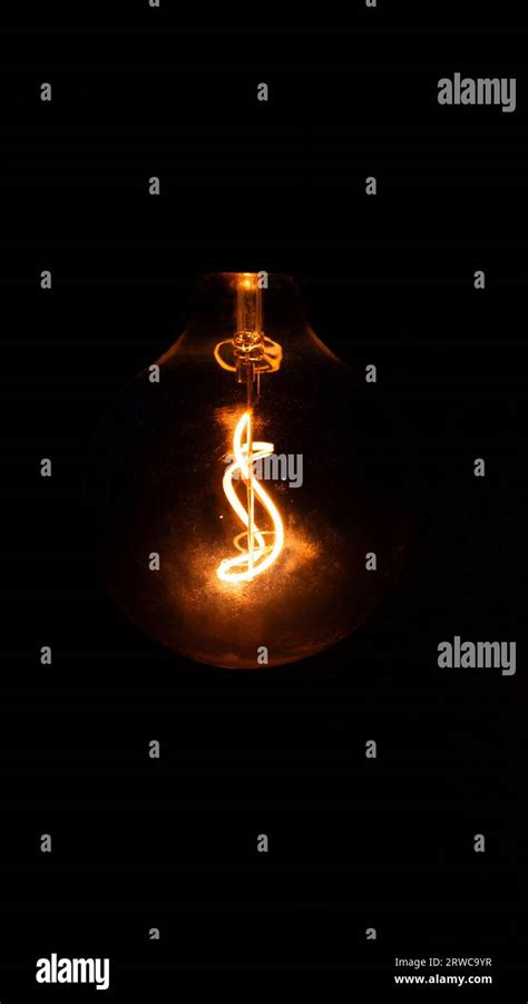 Glowing Orange Lightbulb Stock Photo Alamy