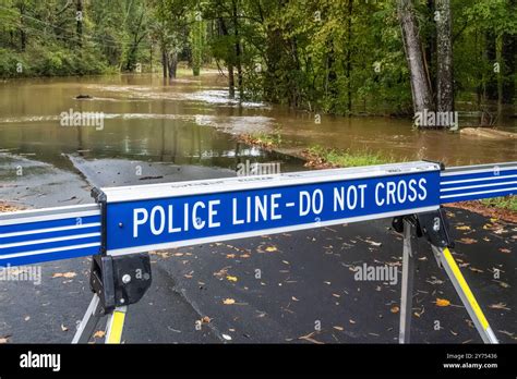 Police Barricade Across A Flooded Street Near The Yellow River In Metro