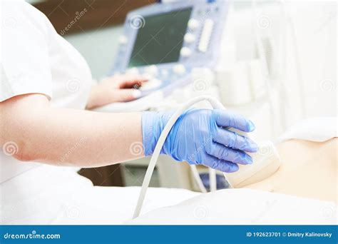 Ultrasound Scan Examining Stomach Of Female Patient Stock Image