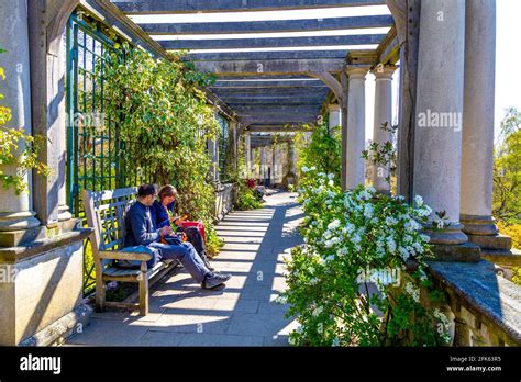 People Enjoying A Sunny Day At The Hampstead Heath Pergola And Hill