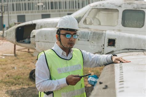 Aircraft mechanic examining airplane wing 21734720 Stock Photo at Vecteezy