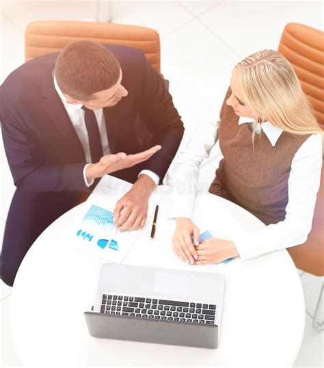 Businessman And Business Woman Discussing Marketing Scheme Stock Photo