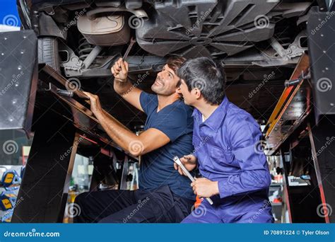 Mechanics Working Under Car Stock Photo Image Of Maintenance