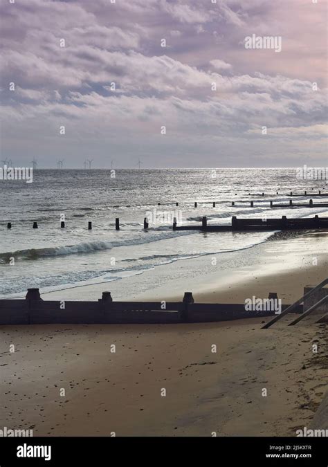 Waves Breaking On Frinton Beach With Sunlight Breaking Through Storm