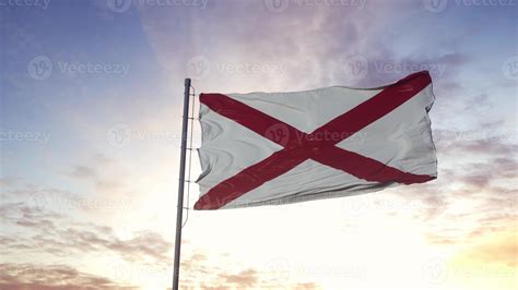 State flag of Alabama waving in the wind. Dramatic sky background. 3d