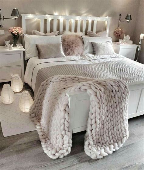 A White Bed Topped With Lots Of Pillows And Blankets On Top Of It S