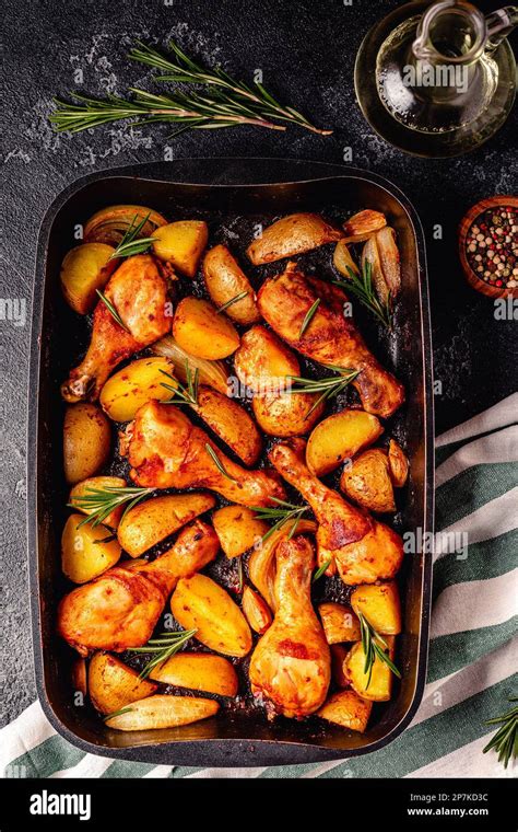 Roasted Chicken Legs With Potatoes And Rosemary Top View Stock Photo