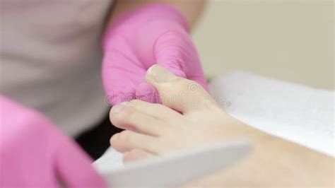 Closeup Footage Of A Hand Adjusting An Iv Roller Clamp With An