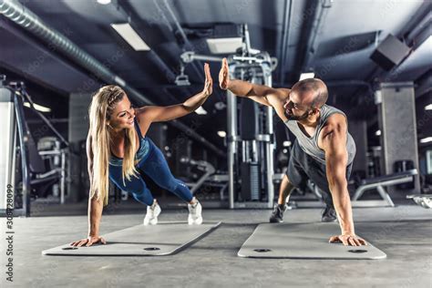 Sport Couple Doing Plank Exercise Workout In Fitness Centrum Man And