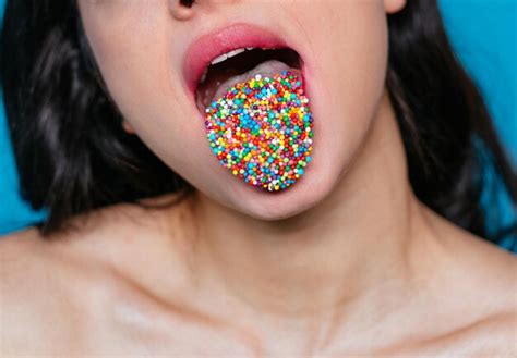 Premium Photo Close Up Of Woman With Candies On Tongue