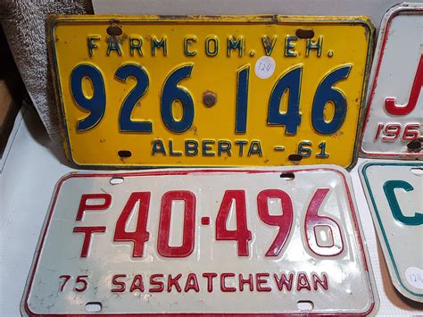 7 SASKATCHEWAN LICENSE PLATES AND 2 ALBERTA LICENSE PLATE