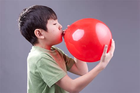 Boy Blows Up Balloon Stock Photo - Download Image Now - iStock