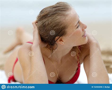 Woman In A Bikini Relaxes On A Sandy Beach At The Ocean Stock Photo Image Of Bikini Skin