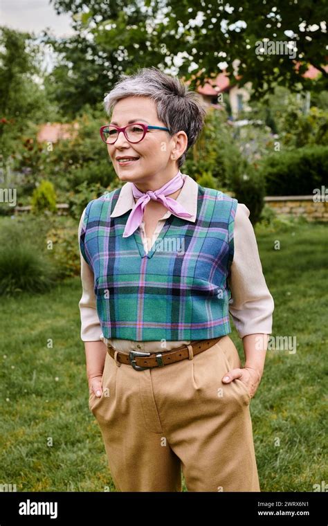Elegant Jolly Mature Woman In Sophisticated Attire Posing Near Her House In England And Looking