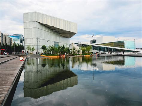 White Concrete Building Near Body Of Water During Daytime Photo Free Architecture Image On