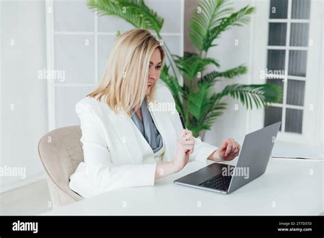 Happy Mature Business Woman Entrepreneur In Office Using Laptop At Work