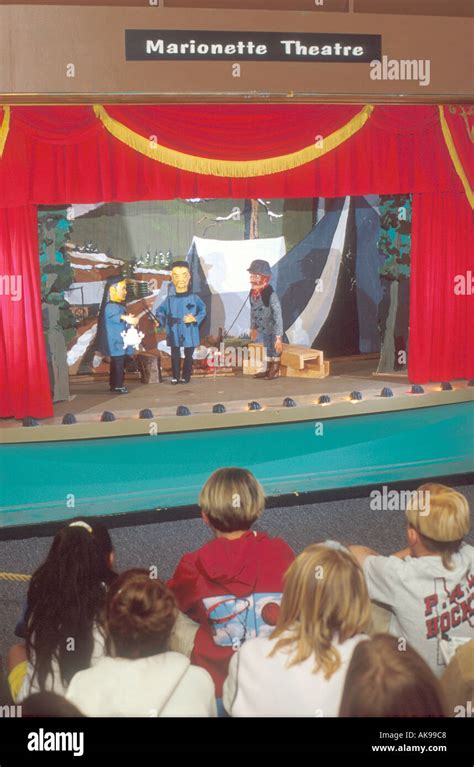 Children watch marionette puppet show Stock Photo - Alamy