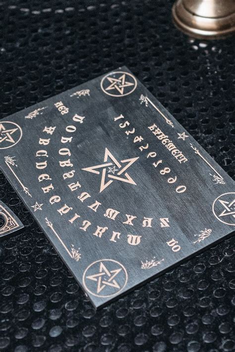 A Quaint Looking Ouija Board And Planchette Ouija Board Start Up