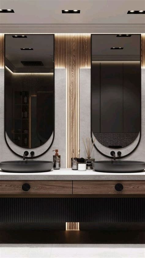 A Bathroom With Two Sinks And Mirrors On The Wall