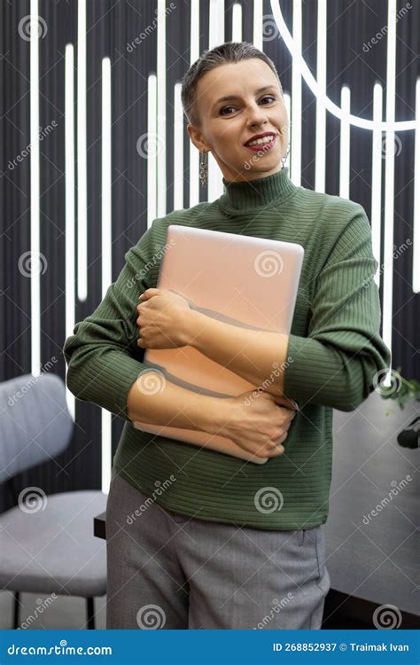 Portrait Of A Successful Mature Female Programmer Against The Backdrop