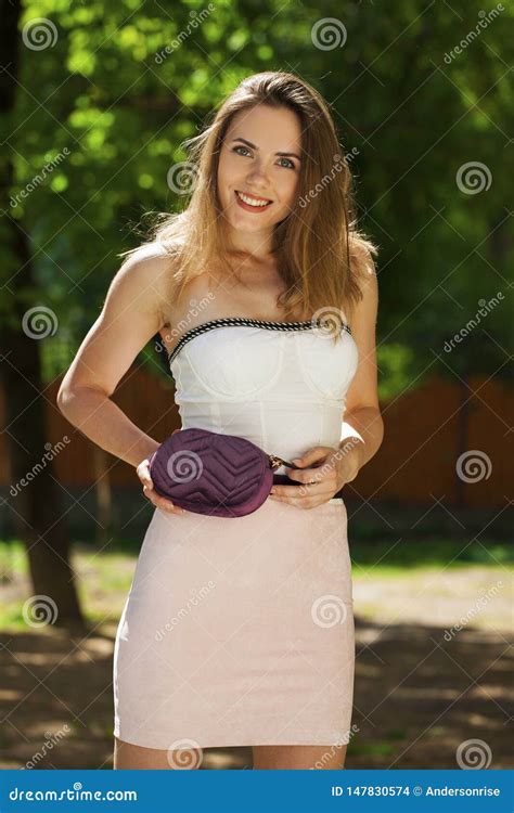 Closeup Portrait Of A Happy Young Brunette Woman In Pink Skirt And