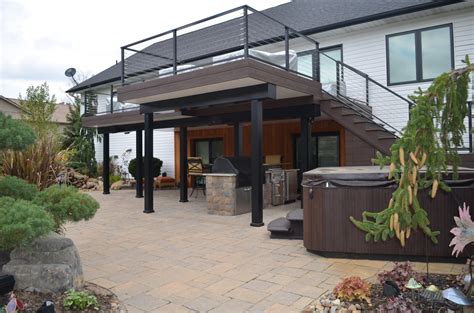 an outdoor hot tub sitting next to a patio with stairs leading up to ...