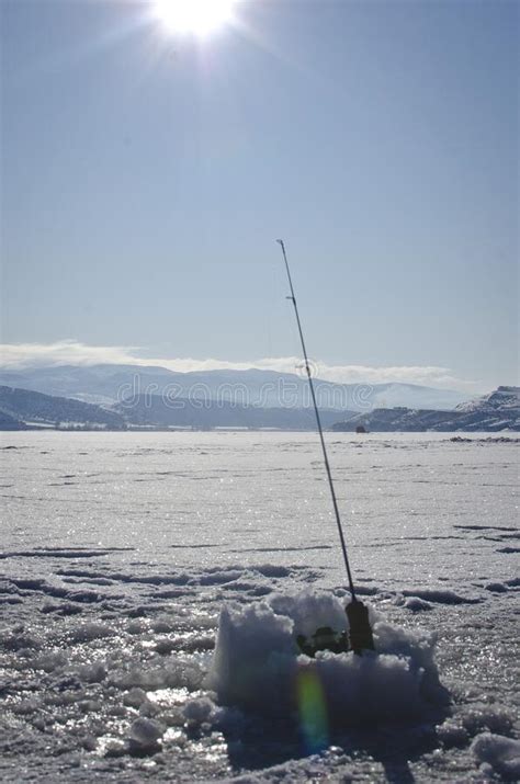 The Solo Fishing Pole Out On The Frozen Lake Stock Photo Image Of