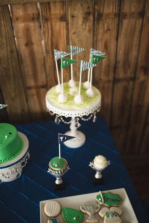 A Table Topped With Lots Of Decorated Cookies And Cake Next To Cupcakes