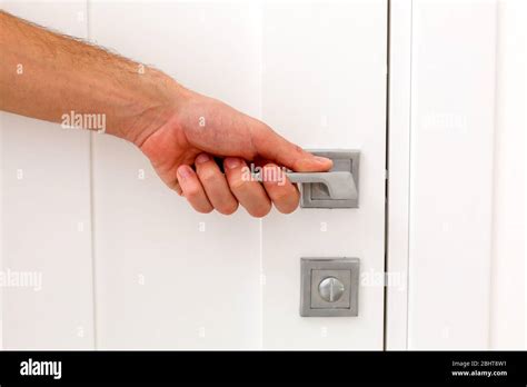 hand opens the door handle Stock Photo - Alamy