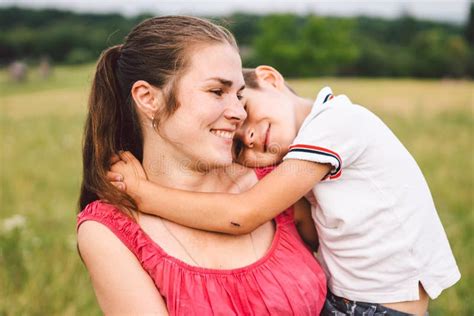 Mother And Son Hugging In Field Happy Mother Embracing Her Son In Park