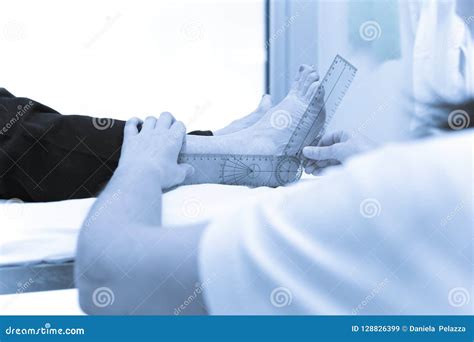 Doctor Or Physiotherapist Meausuring Active Range Of Motion Stock Image