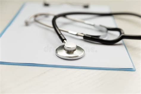 Stethoscope And Blue Clipboard With A Few Sheets Of Paper Medical