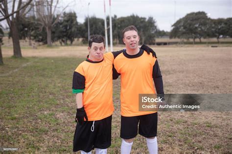 Portrait Of Two Soccer Players With Down Syndrome At Field Stock Photo