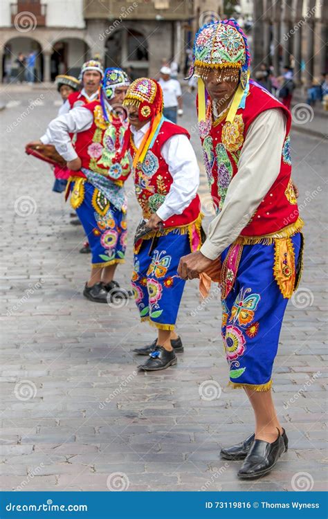 Colourfully Dressed Men Perform Down A Cusco Street During The May Day