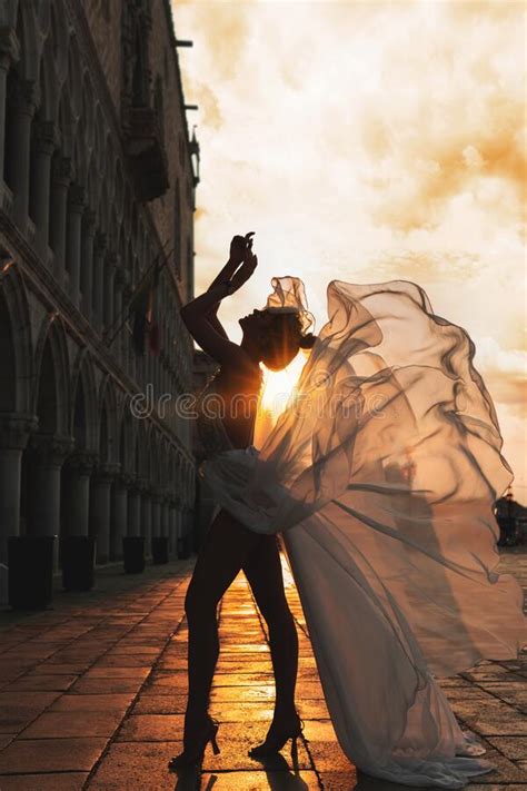 Woman Wearing Beautiful White Dress Walking On A Street Of The Venice