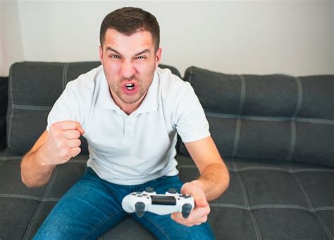 Premium Photo Young Man Sit In Room Playing Intense Game Alone