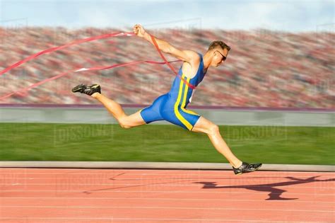 Runner Crossing The Finish Line Stock Photo Dissolve