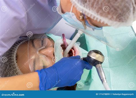 The Dentist With The Help Of A Carpule Syringe Injects Anesthesia Into