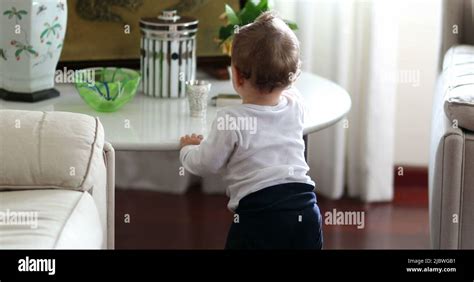 Baby Learning To Stand Infant Standing Up Holding Into Table Furniture