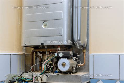 Technician servicing on gas boiler for hot water and heatingの写真素材