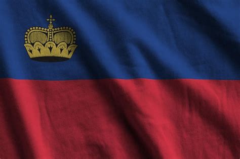 Premium Photo Liechtenstein Flag With Big Folds Waving Close Up Under