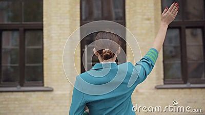 Back View Of Slim Brunette Stewardess Standing In Front Of Building And