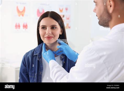 Endocrinologist Examining Thyroid Gland Of Patient At Hospital Stock