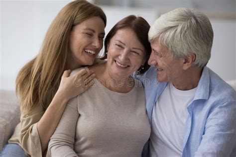 Cheerful Adult Daughter And Senior Husband Hugging Mature Mom Stock Image Image Of Male Talk