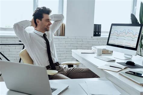 Relaxed Man Holding Hands Behind Head While Sitting At His Working Place In Office Stock Image