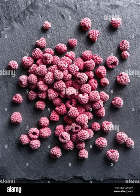 Frozen Raspberry On Black Slate Top View High Resolution Product