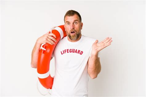 Premium Photo Senior Lifeguard Man Isolated On White Wall Surprised