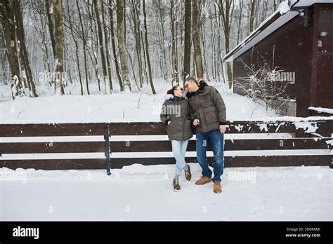 A Beautiful Young Couple In Love Walking Through Winter Park In