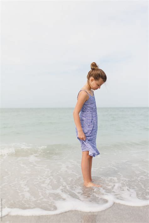 Profile Of A Preteen Girl Looking Into The Ocean With A Soft Smile By