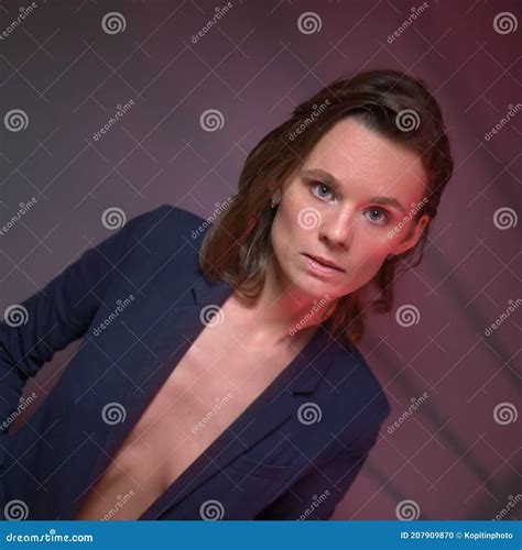 Beautiful Woman In A Jacket Worn On A Naked Body Gray Background With Red Backlight Stock Photo